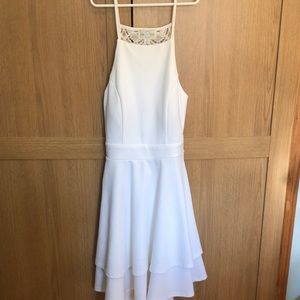 Unused, small, white dress with an open, lace back.